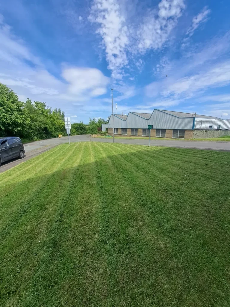 Large commercial lawn freshly mowed with stripes beside a business park in Glasgow
