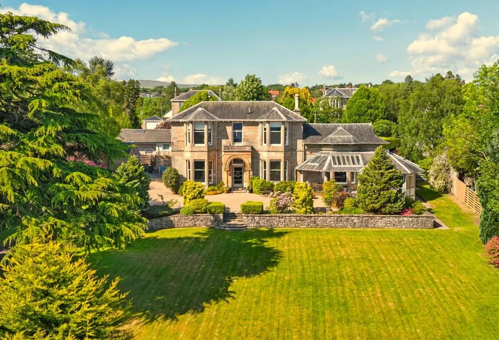 Sandstone villa with a large striped lawn and mature gardens in Helensburgh